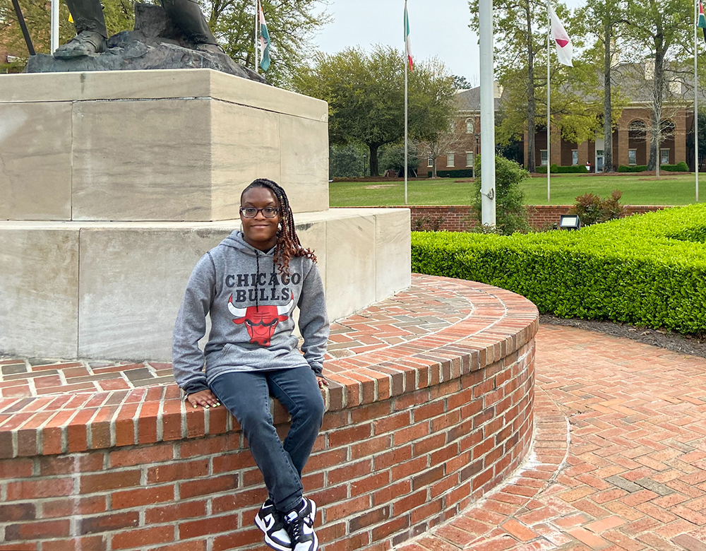 A student poses by the fountain on the Dothan Campus.