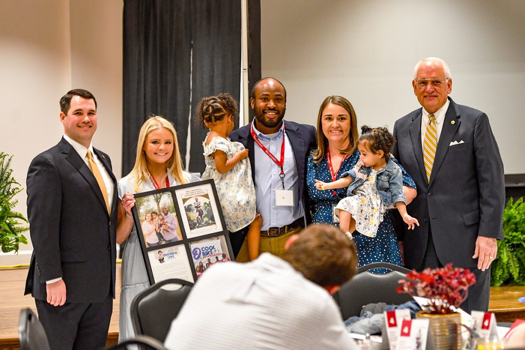 A group photo with William Filmore, student Avery Zubaly, Drs. Heather and Onik Lewis, their children and Chancellor Hawkins.