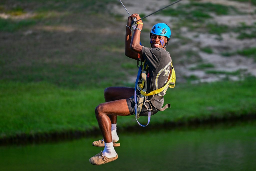 A student ziplines at Butter and Egg Adventures