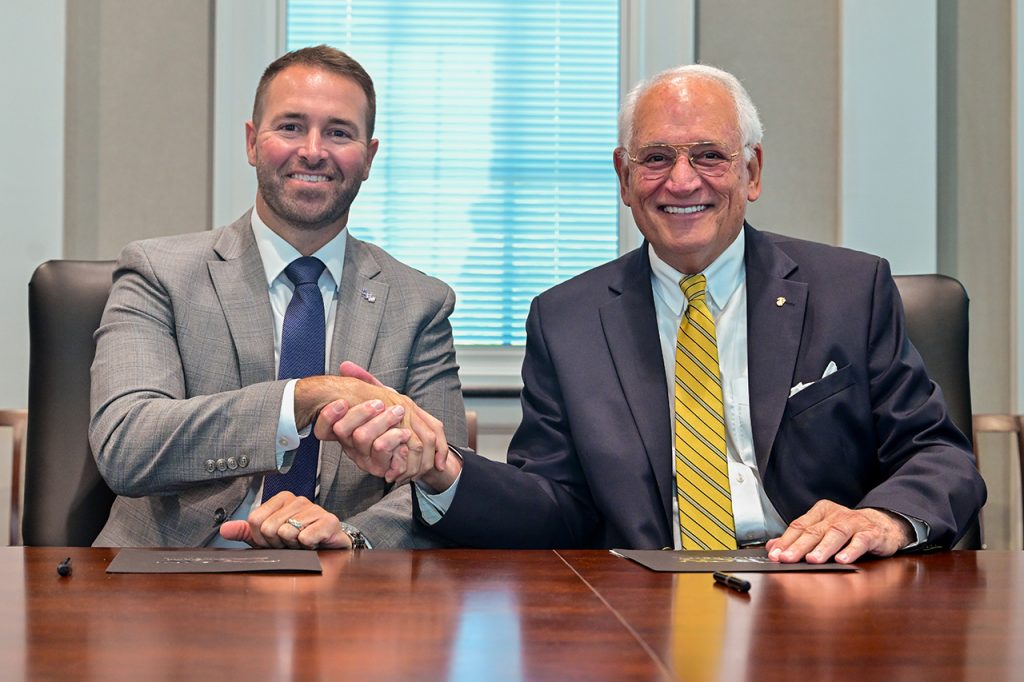 TROY Chancellor Dr. Jack Hawkins, Jr., right, and Dr. Brock Kelley of Lurleen B. Wallace Community College form a partnership to pave the way for LBW students to earn an undergraduate electronics engineering technology degree. (TROY photo/Joey Meredith)