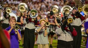 High school band members perform during TROY's halftime with the Sound of the South