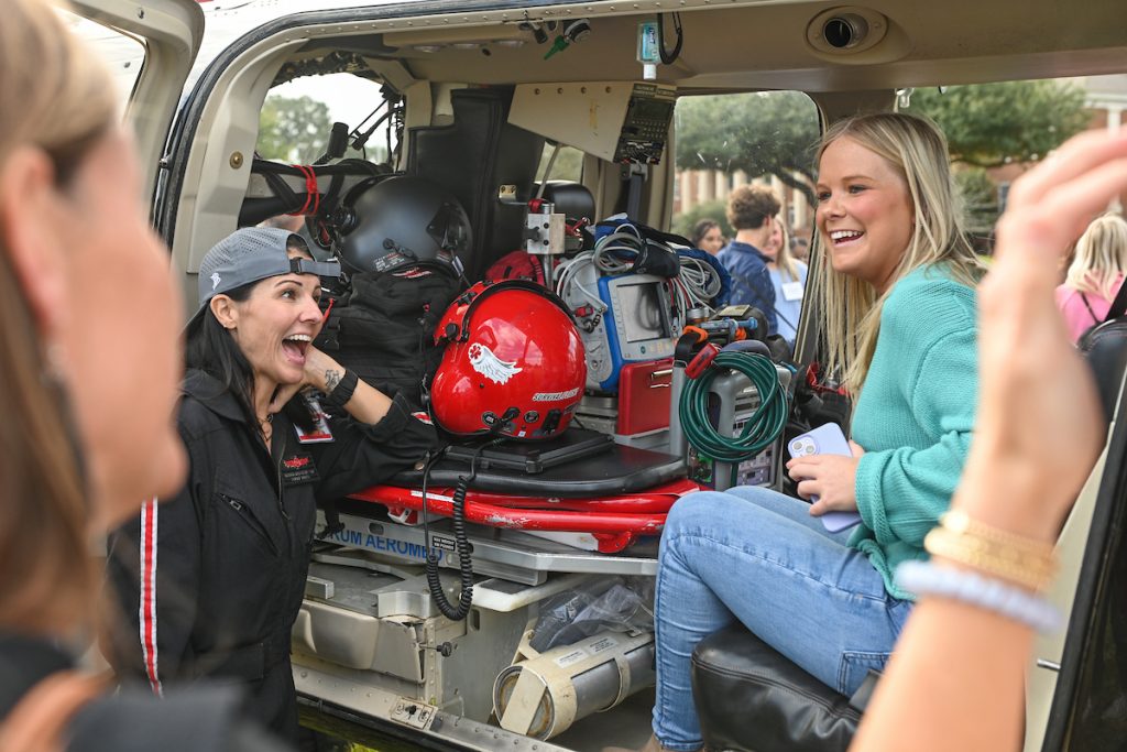 Students visiting with Survival Flight's team and sitting inside their helicopter. 