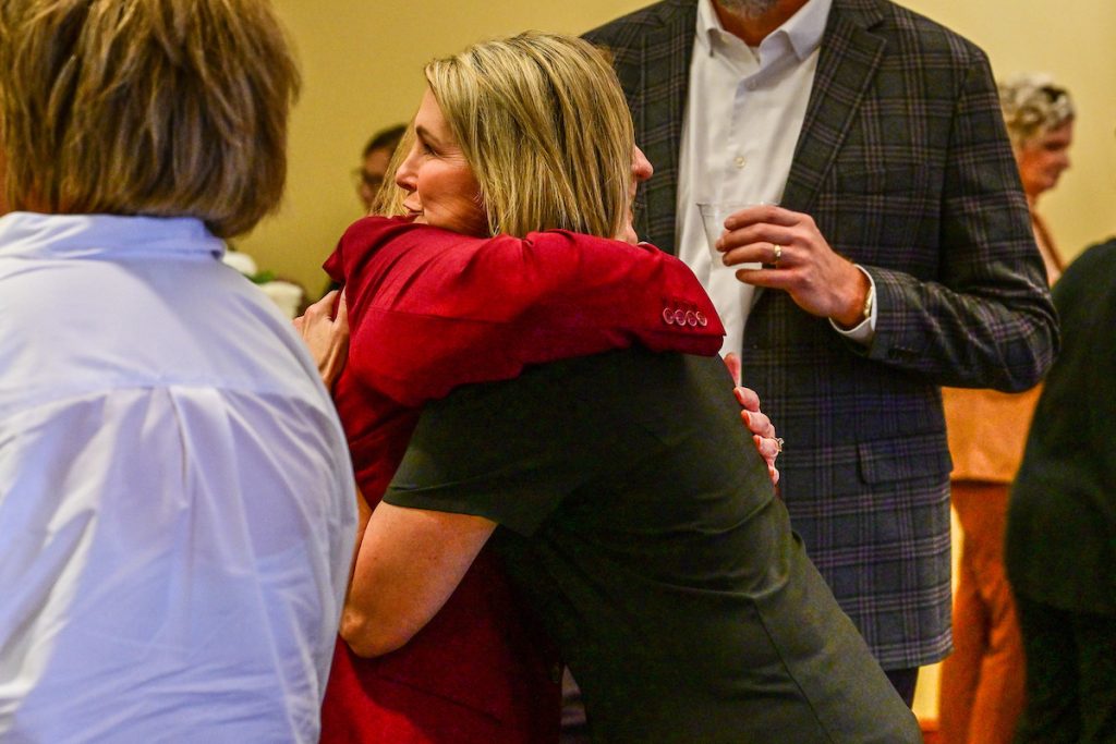 Vardaman hugging fellow colleague.