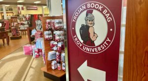 a sign pointing students to where they can pick up their Trojan Book Bag