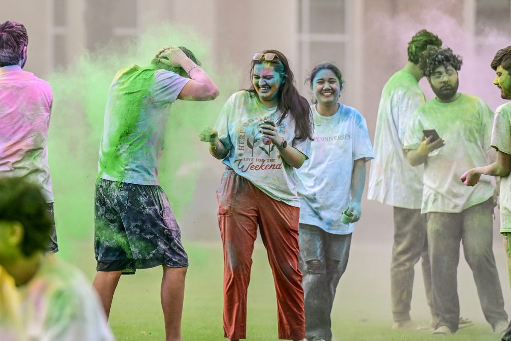 Students throw colored powders and dyes at each other during the Holi Festival.