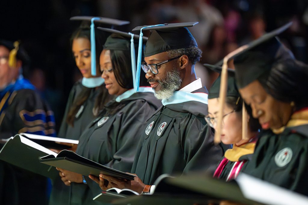 Graduates sing the Alma Mater at the end of the ceremony.
