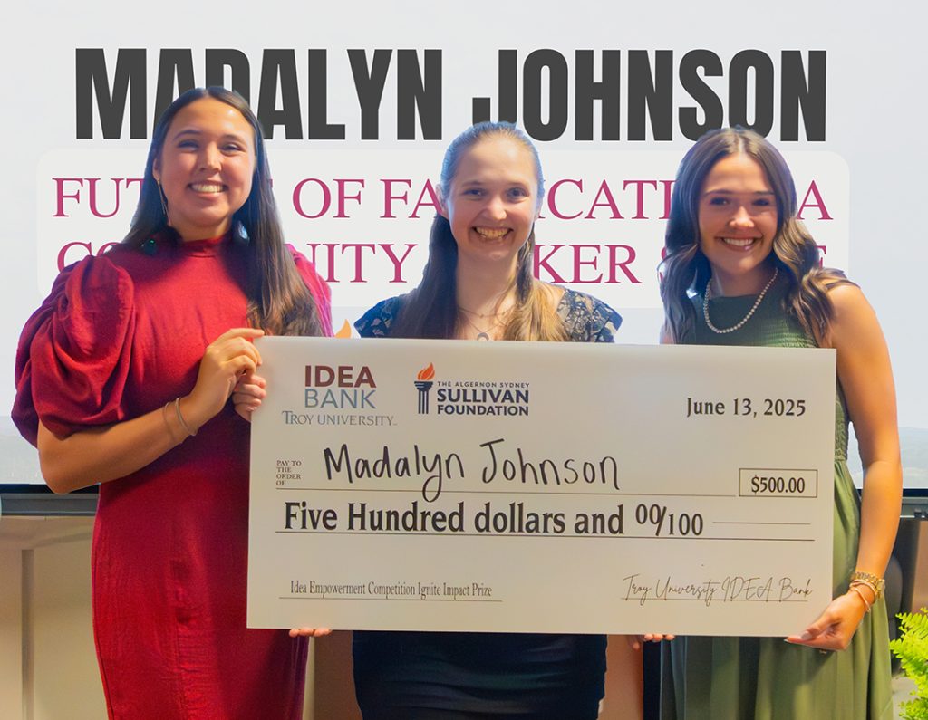 Madalyn Johnson receives a $500 check from the Sullivan Foundation