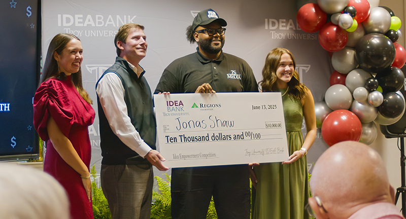 Jonas Shaw is presented a check from Regions Foundation for $ 10,000.