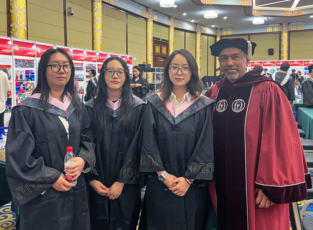 Sohail Agboatwala, right, with 1+2+1 Program graduates in Beijing.