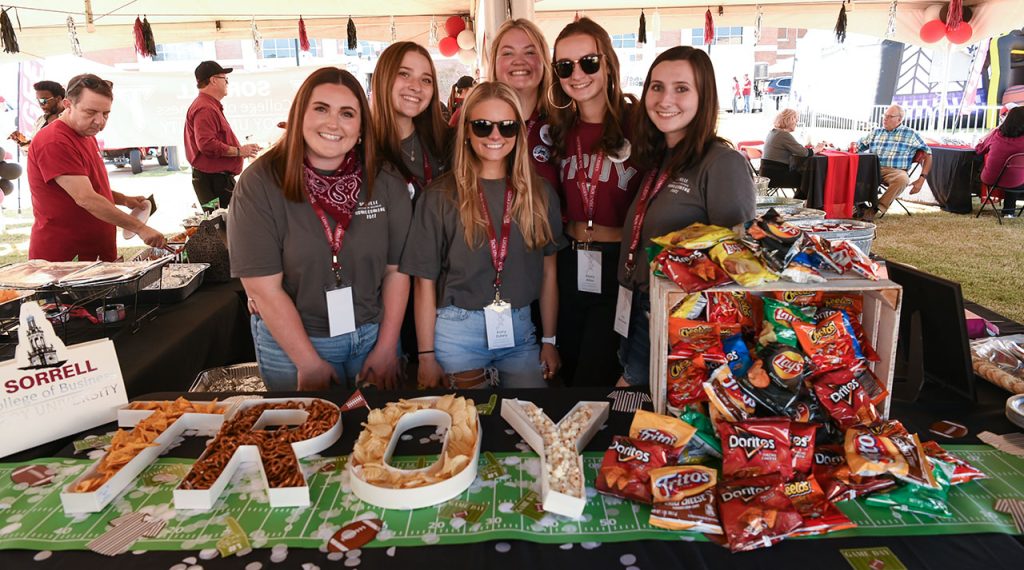 A group of HSTM students who helped plan and execute a homecoming tailgate tent event.