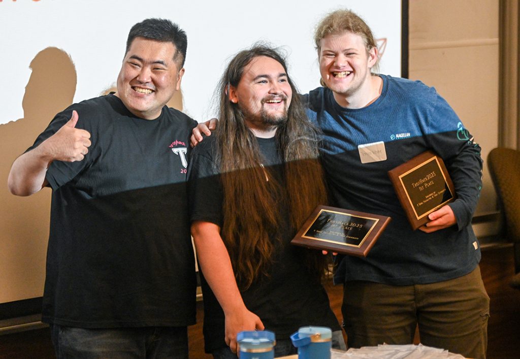 Dr. Jung with first place team members Charles Wood and Taylor White. Teammate Danyael Vera not pictured.