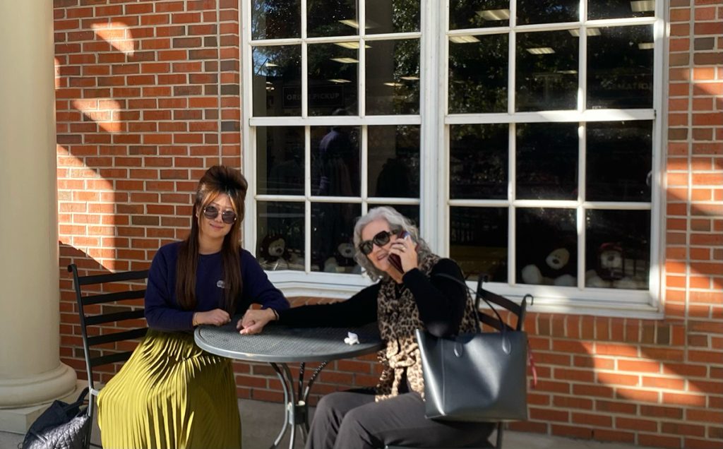 Shu and Dr. Theresa Johnson at their old coffee and conversation table outside of the bookstore.