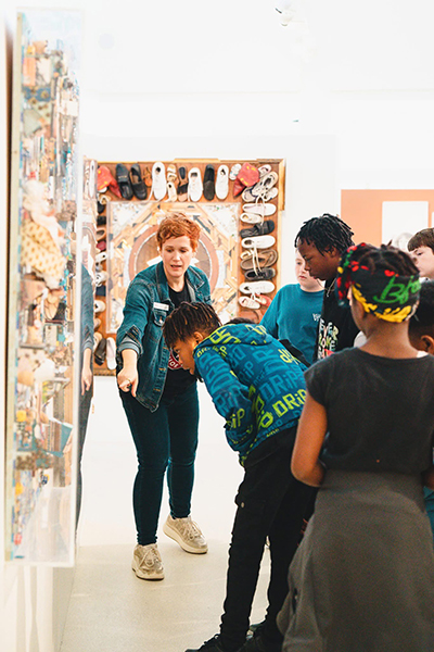 IAC Director and Curator Carrie Jaxon describes artwork to elementary school students during the annual IAC Trojan Junior Warriors program.