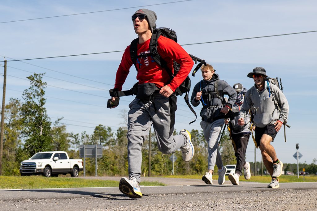Three ATO walkers run to a rest stop on Wednesday's final push to Panama City Beach.