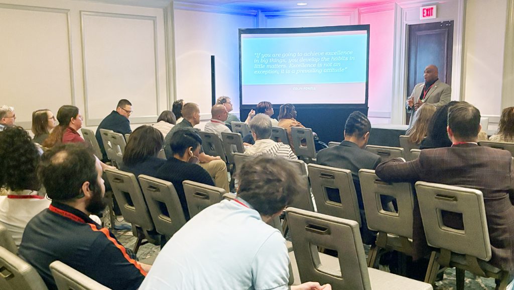 Michael Jackson of Troy University's Continuing Education and Outreach division speaks to group of people attending the NPMA Transit Retreat in Mobile.