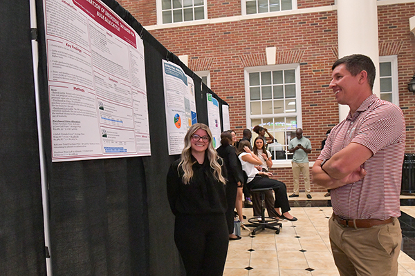 a photo of a student and a faculty member reviewing research