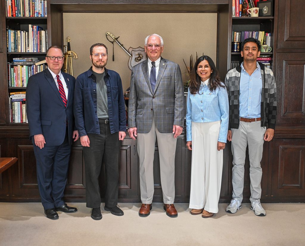 Dr. Kerry Palmer, Dr. Jiri Minarcik, Chancellor Hawkins, Dr. Priya Menon and Dr. Rakshak Adhikari in the Chancellor's Office.