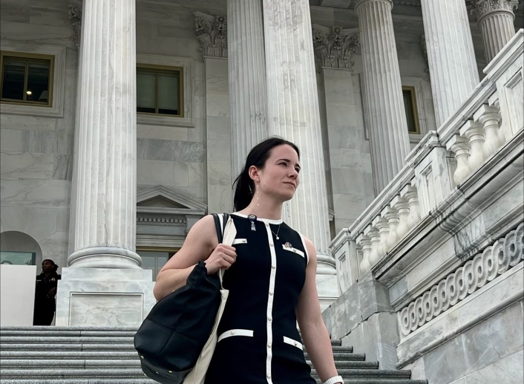 An image of TROY alumna, Madison Bright, walking down the stairs outside of Capitol Hill