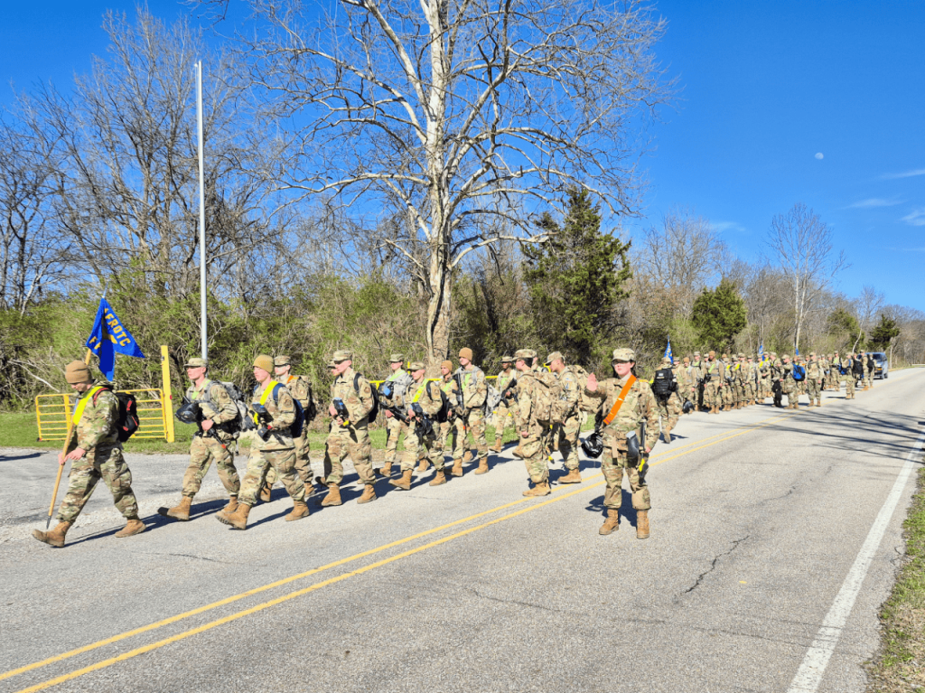 Troy University AFROTC Cadets marching in a line at Camp Atterbury in Indiana.