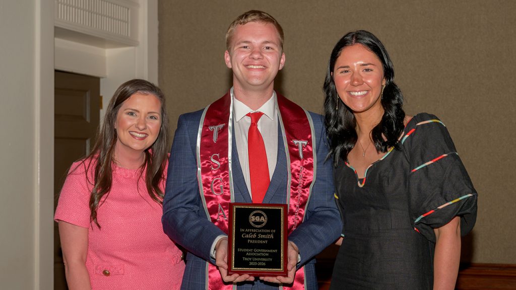Outgoing SGA President Caleb Smith receives an appreciation award for his service, shown here with Dr Korrie Lynn Williamson and Olivia Barron.