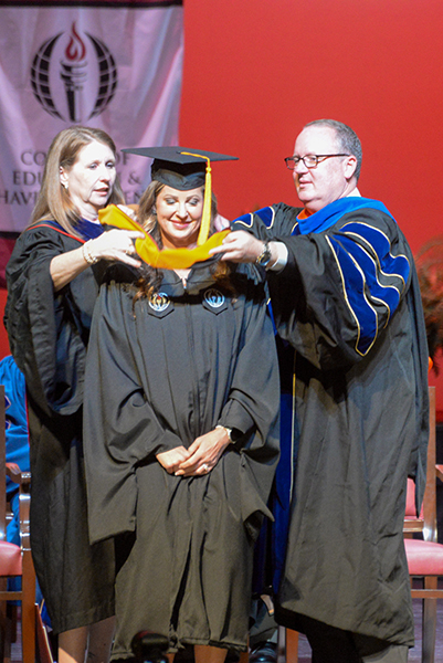 Autumn Lindsey is hooded while receiving her master's in nursing degree during spring commencement at the Montgomery Campus on May 21.