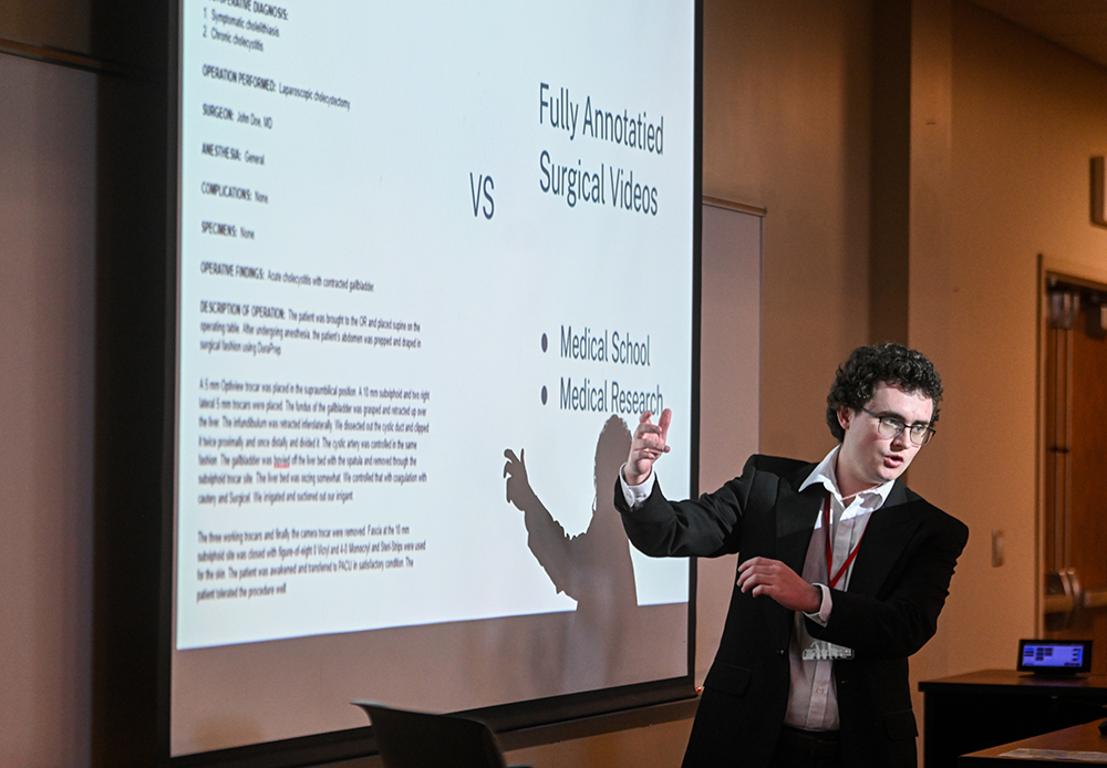 A conference attendee gives a presentation on medical-related computer science applications.