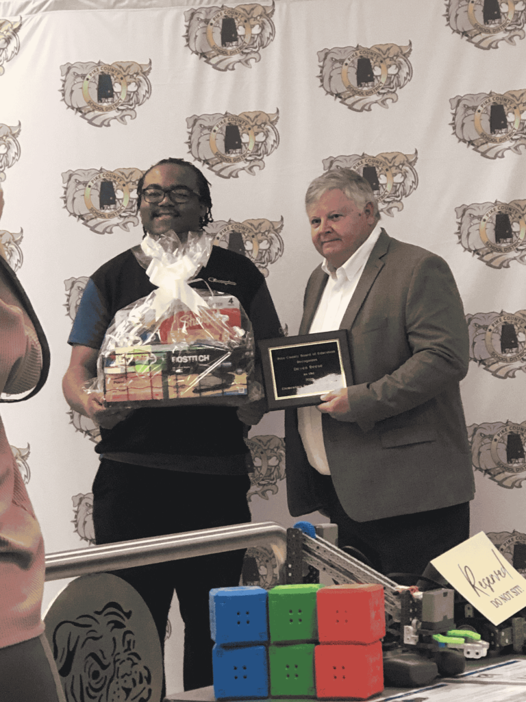 Deven Reese receiving his Teacher of the Year award from Pike County Board of Education.