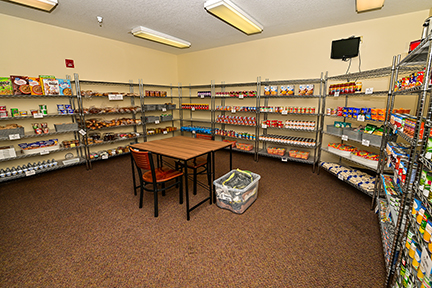 a room of shelves holding canned food items