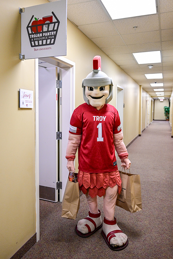 Trojan mascot T-Roy with grocery bags