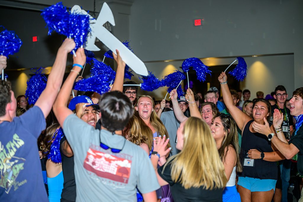 students in the blue Wave Runner IMPACT group celebrate after winning the Spirit Stick.