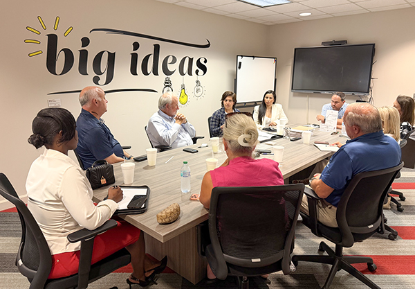a photo of people around a conference table