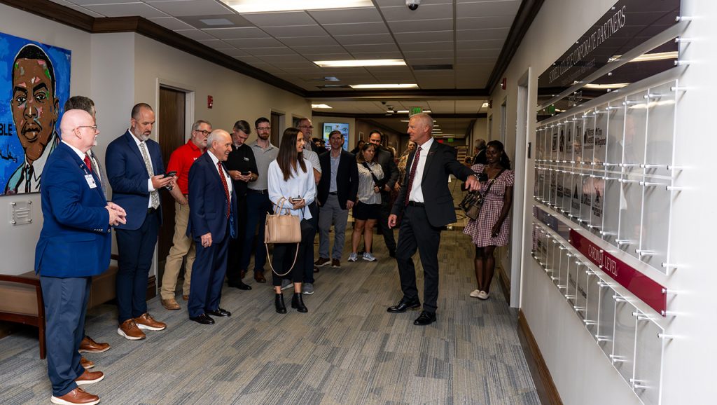 Dr. Steve Grice, Interim Dean of the Sorrell College of Business, shows Corporate Partner Wall to participants in Tuesday's ceremony.