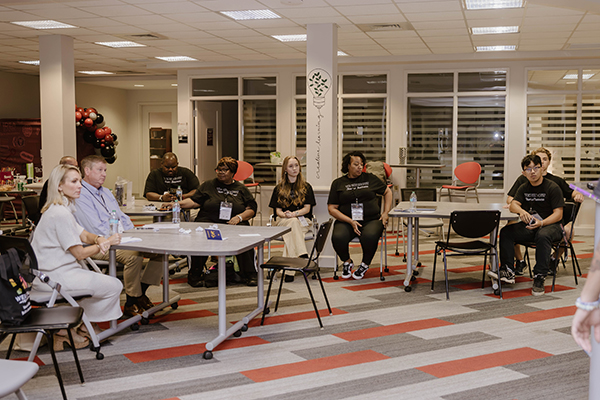 a group of people sitting in a classroom
