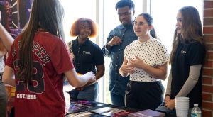 students browsing tables at Trojan Day