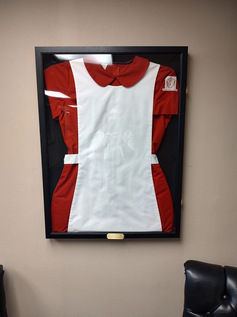 Maroon Uniform Top with a TROY Patch on the sleeve of the first class to graduate from TROY ASN Program.
