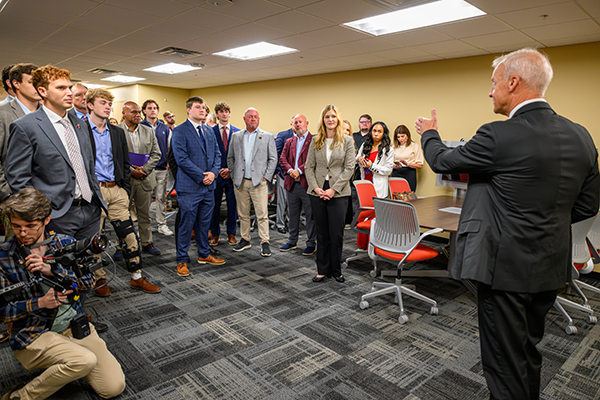 a man speaking before a group of people